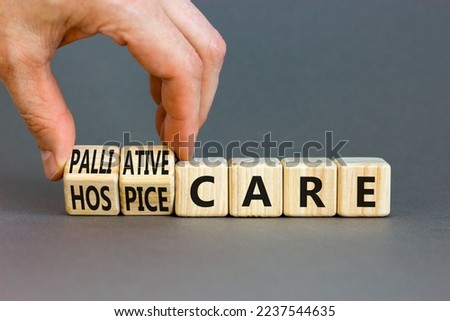 Palliative or hospice care symbol. Concept word Palliative care Hospice care on wooden cubes. Doctor hand. Beautiful grey table grey background. Medical palliative or hospice care concept. Copy space. Royalty-Free Stock Photo #2237544635