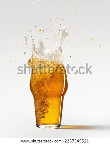 Ice cube falling down. Glass with chill foamy lager beer isolated over grey background. Splashes. Concept of alcohol, oktoberfest, drinks, holidays and festivals. Copy space for ad.