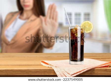 Young woman make stop sign showing on junk drink