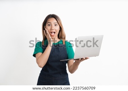 Young Asian business owners are excited by the good news while playing on computer laptop isolate on white background.