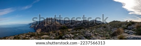 panorama landscape photography of the mallorca island with the Mediterranean sea  with a blue sky and the mountains along the seashore 