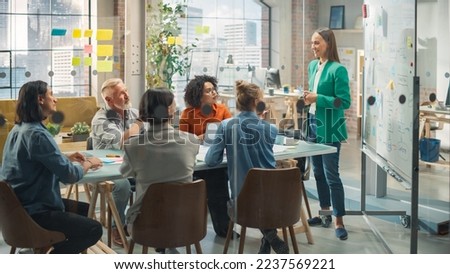 Focused Group of Multiethnic People in a Meeting in Office. Young White Female CEO using Whiteboard to Pitch a Startup Idea to Potential Investors and Answer Questions. Brainstorming Concept Royalty-Free Stock Photo #2237569221