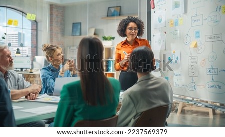 Diverse Modern Office: Successful Black Female Digital Entrepreneur Uses Whiteboard with Big Data, Statistics, Talks about Company Growth, Discusses Strategy with Investors, Top Managers, Executives