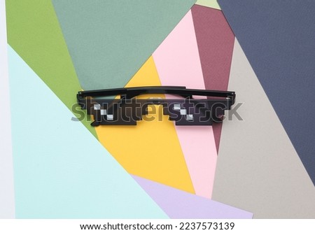 8 bit pixelated sunglasses on colored background