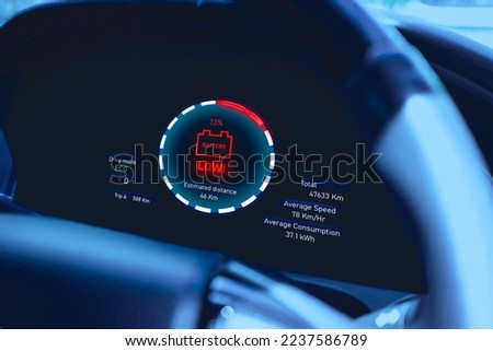 Low battery warning light on instrument panel of EV electric vehicle, Alternative energy concept of saving the world Royalty-Free Stock Photo #2237586789