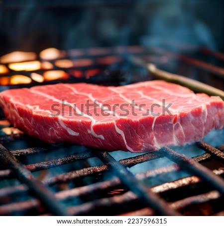 Marbled beef or bloody grilled steak on a background of flames. Shallow depth of field	