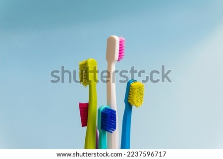 Five Toothbrushes on blue background.