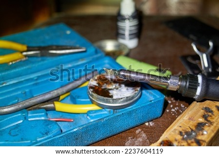 Photo of soldering iron, rosin and solder on the box Royalty-Free Stock Photo #2237604119