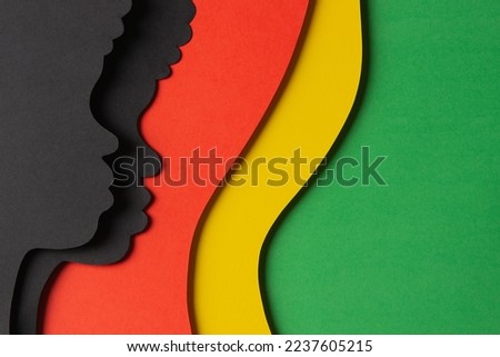 Black History Month color background. African Americans history celebration. Abstract geometric red, yellow, green color background with black paper cut people silhouette. Top view Royalty-Free Stock Photo #2237605215