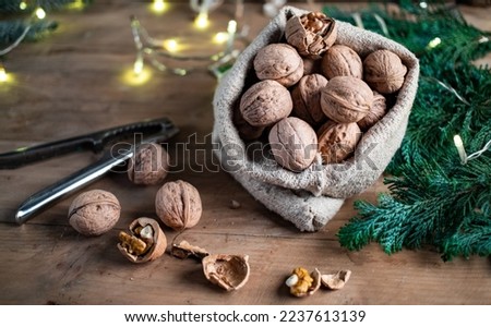 festive christmas nuts tumbling from a burlap bag