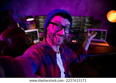Photo of cool excited freelancer wear hat eyeglasses inviting late night shift indoors workplace workstation loft