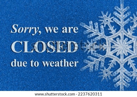Sorry we are Closed due to weather with a snowflake on blue glitter Royalty-Free Stock Photo #2237620311