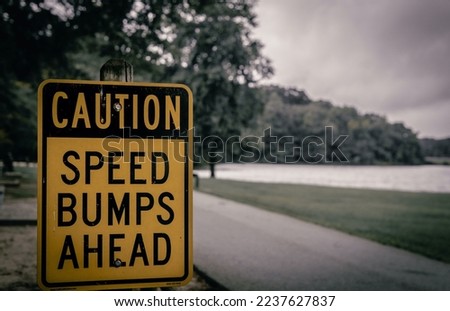 On the road street sign and  symbole for caution speed numb ahead