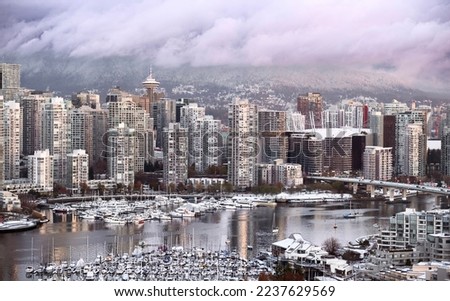 Vancouver downtown snow in winter. Cambie bridge. False Creek with boats. British Columbia. Canada