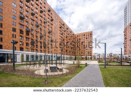 Architectural photography of a residential complex with an internal landscaped courtyard in the new district of Moscow . Modern panel housing construction . 