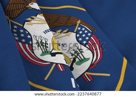 Utah US state flag with big folds waving close up under the studio light indoors. The official symbols and colors in fabric banner