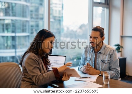 Hispanic male candidate having job interview with Asian businesswoman during the meeting in the office. Royalty-Free Stock Photo #2237655693