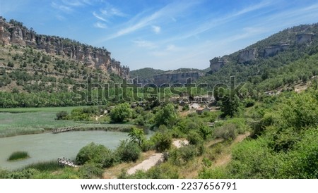 The lagoon of Uña and its mountains is located in the town of Uña, in the province of Cuenca (Castilla La Mancha, Spain). In the photo we can see mountains and also many green trees. Spain