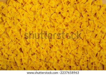 Raw Farfalle Pasta Texture Background, Yellow Dry Butterfly Noodles Pattern, Wheat Bow Macaroni Mockup, Uncooked Farfalle Background Top View, Copy Space
