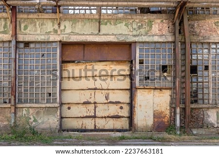 Closed Big Door at Old Factory Industrial Building Royalty-Free Stock Photo #2237663181