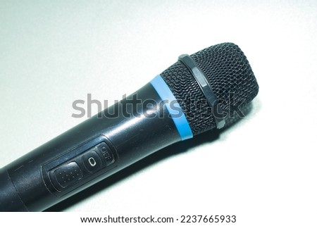 black microphone on white paper background