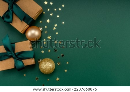 Christmas composition. Christmas gifts and decorations on green background.
