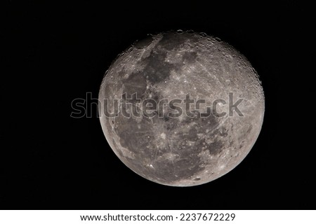 The Moon is an astronomical body that orbits planet Earth, being Earth's only permanent natural satellite. The moon, black and white photo.