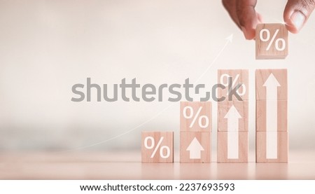 Interest rate and dividend concept, wooden block with percentage symbol and up arrow, return on stocks and mutual funds, long term investment for retirement. Royalty-Free Stock Photo #2237693593
