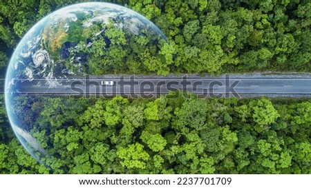 Electric car and EV electrical energy for environment, EV car on forest road with earth planet going through forest, Ecosystem ecology healthy environment, Electric car with nature, Save earth energy. Royalty-Free Stock Photo #2237701709
