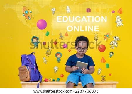 Online Education Concept, Cute little boy learning the internet or playing games with his laptop computer to enhance imagination.