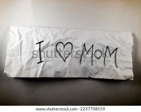 an inscription "i love mom" on white paper