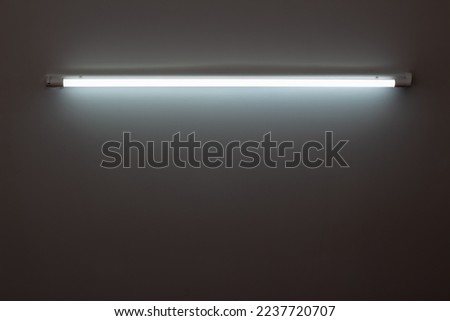 White neon lamp on a white wall Royalty-Free Stock Photo #2237720707