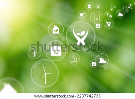 Green defocused background with sun rays and multiple icons inside floating bubbles as a symbol of protect environment and nature. Concept of sustainable ecology and carbon neutral air.