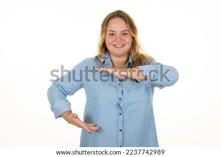 Happy oversize woman makes frame gesture smiles on white background