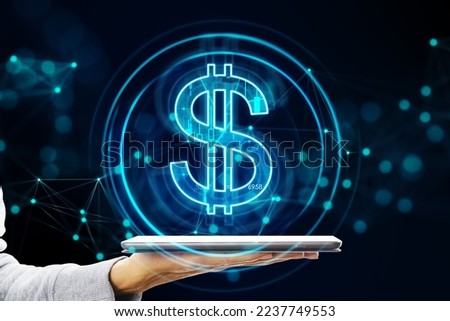 Online banking, digital money exchange and financial application concept with virtual blue dollar sign projected from digital tablet in man hand on dark background