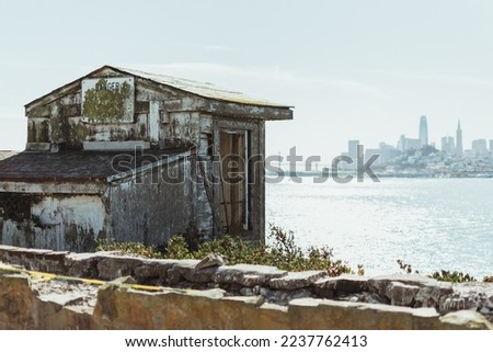 The wooden house of the guards on Alcatraz Island with the skyline of San Francisco in the background. California, USA. 