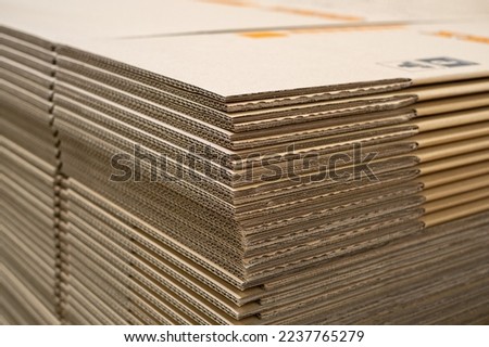 Stack of new Disassembled condition packaging corrugated carboard boxes. lot of cardboard packaging. not folded. Production distribution concept. Royalty-Free Stock Photo #2237765279