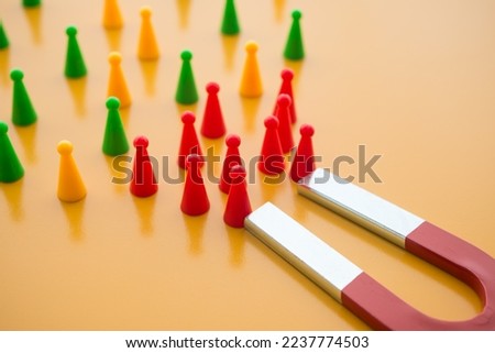 Horseshoe magnet attract red people from crowd on yellow background. Attracting target customer in marketing business and human resources (hr) recruitment best person concept. Right man on right job.
