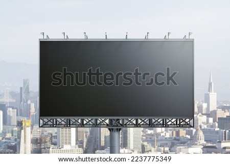 Blank black horizontal billboard on cityscape background, front view. Mockup, advertising concept