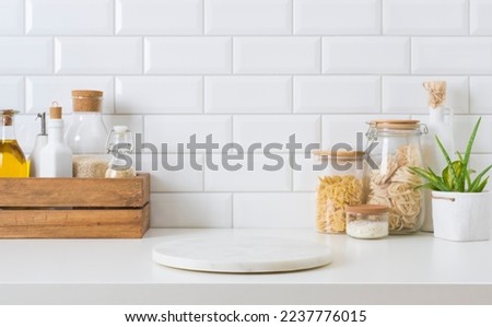 Marble stone stand on kitchen table with various food ingredients