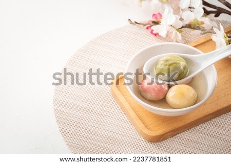 Colored glaze style big tangyuan (tang yuan, rice dumpling balls) with syrup soup in a bowl. Royalty-Free Stock Photo #2237781851