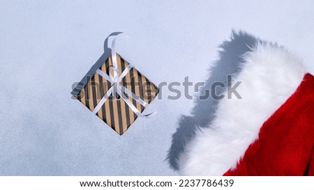 Christmas sock and gift box with white ribbon on grey background. Space for text. Mockup. High quality photo