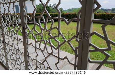 Abstract ornament and decorative pattern background of vintage white cast iron sliding fence gate in iron metal Islamic geometric pattern