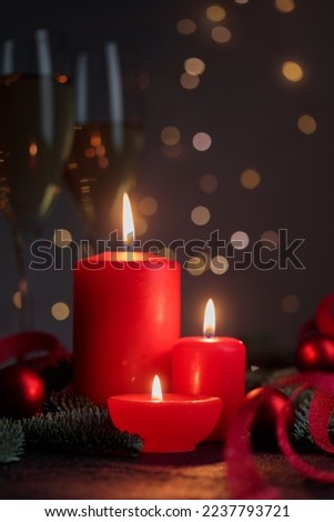 Red candles on dark background with bokeh lights Vertical with copyspace