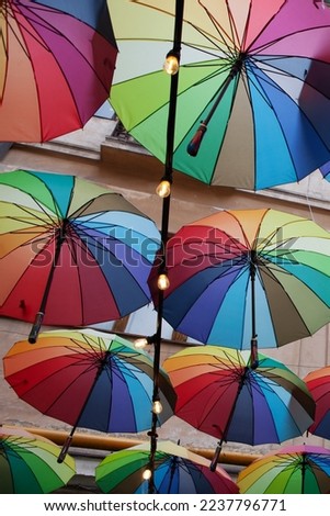 Colorful umbrellas background. Colorful umbrellas in sky. Street decoration. Concept of protection, brightness of life. Selective focus. Copy space