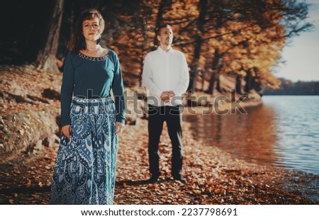 romantic couple in love by the lake in autumn.