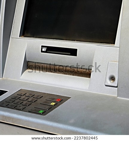 ATM machine making a withdrawal with credit card with people stock photo