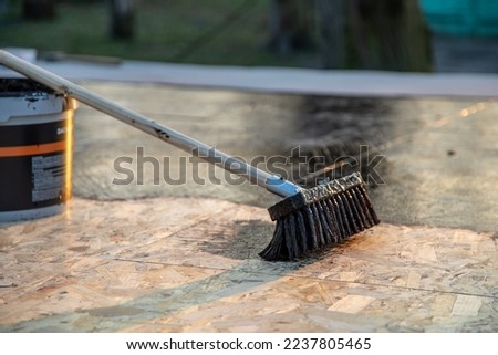 Covering and sealing the roof against rain and moisture Royalty-Free Stock Photo #2237805465