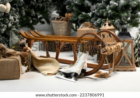 Christmas decorations. Wooden sledges, skates, lanterns and gifts under the Christmas trees.