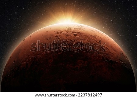 Beautiful red planet mars with craters with dawn light sun. Space concept and new home planet at sunset